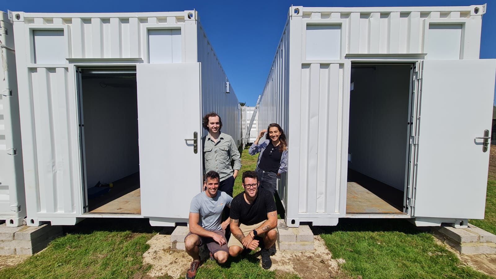 Flybox Founders outside Flybox containers under construction